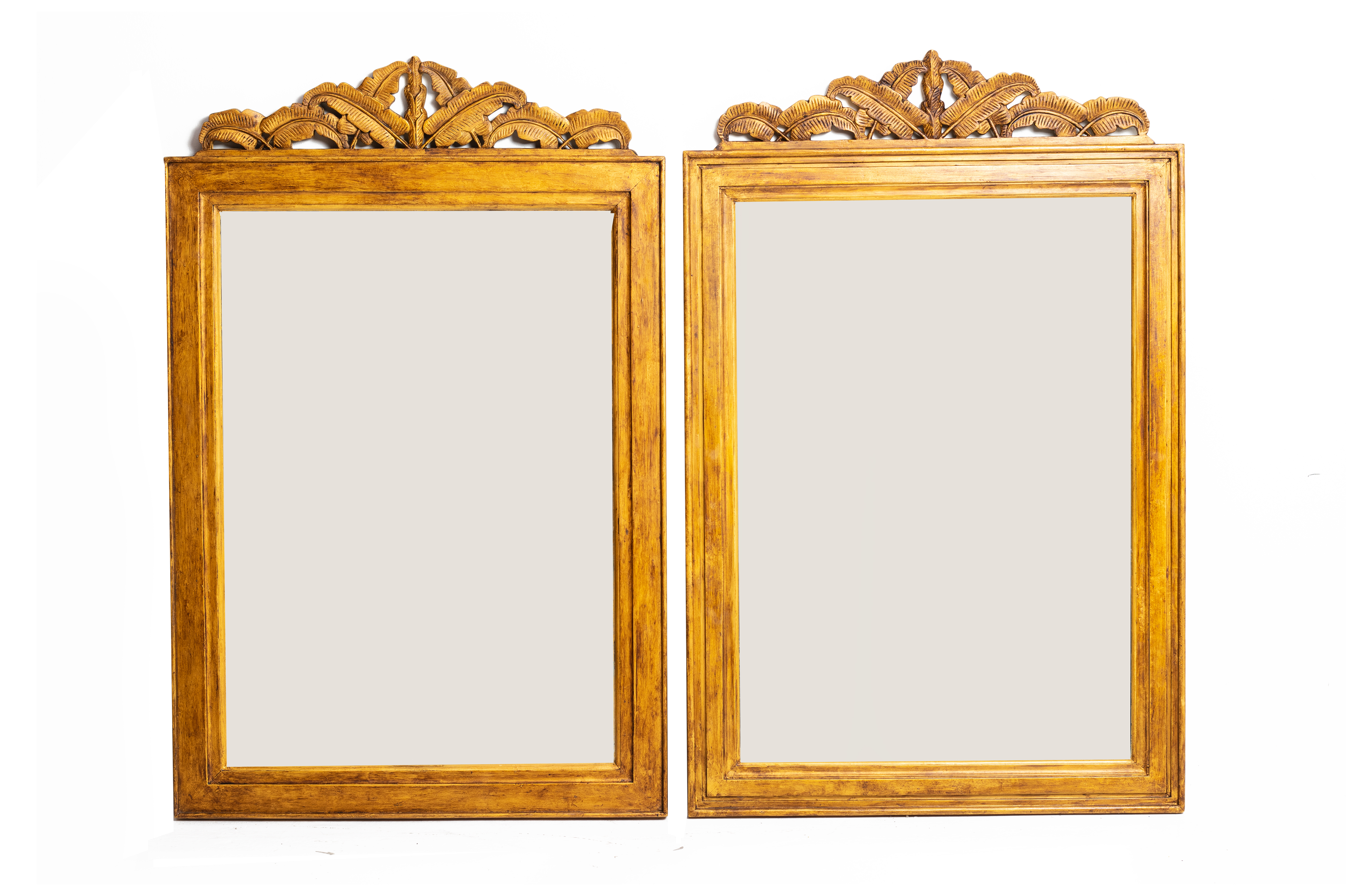 A PAIR OF CARVED GILTWOOD MIRRORS