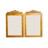 A PAIR OF CARVED GILTWOOD MIRRORS
