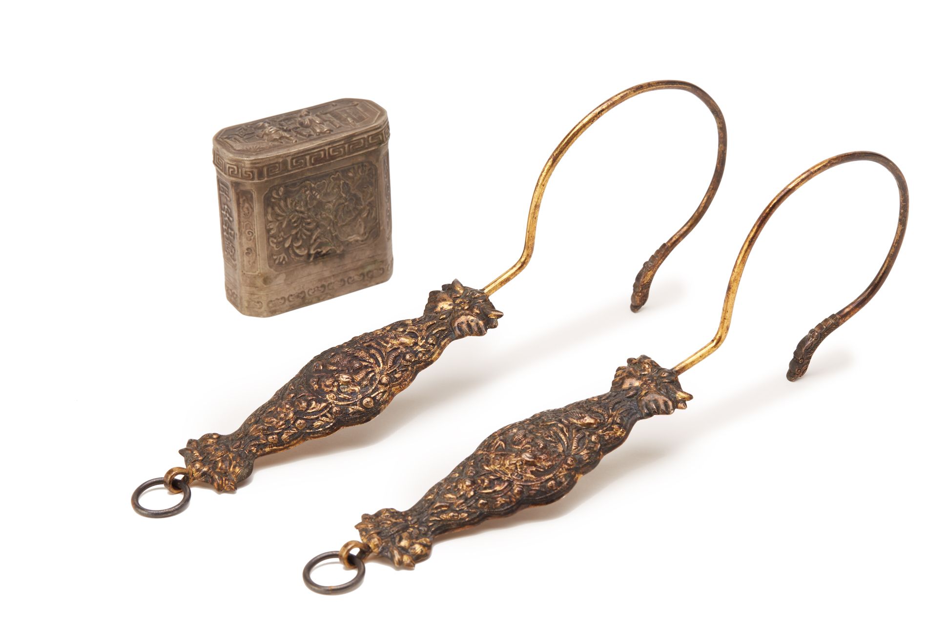 TWO PERANAKAN CURTAIN HOOKS AND A WHITE METAL OPIUM BOX