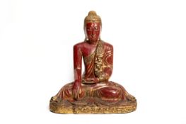 A SOUTHEAST ASIAN RED LACQUER AND GILT DECORATED BUDDHA