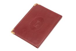 A MUST DE CARTIER BURGUNDY LEATHER NOTEBOOK COVER