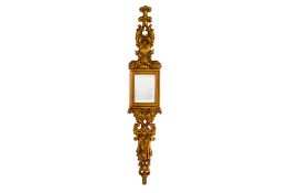 AN ORNATE GILTWOOD CARVED RECTANGULAR WALL MIRROR