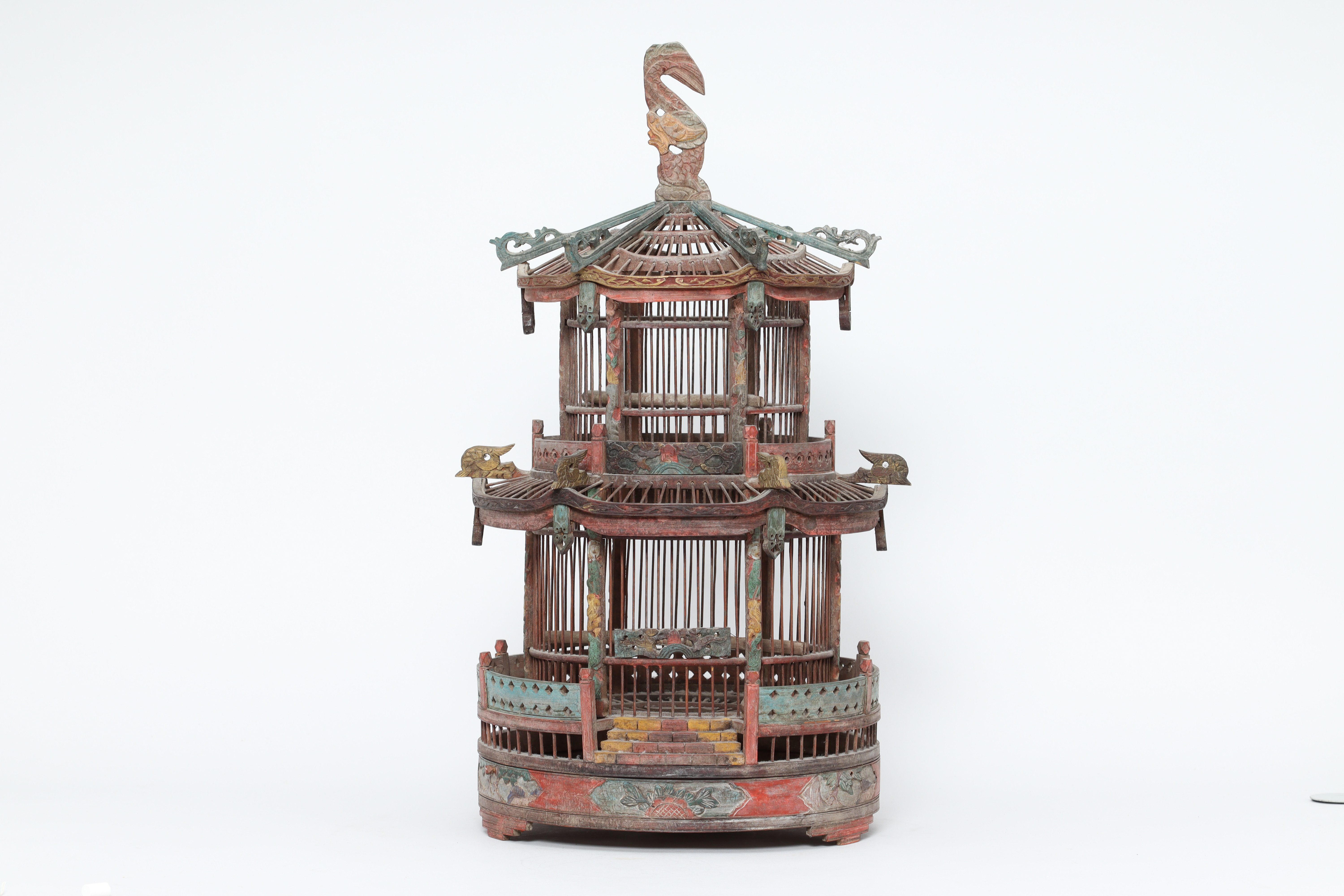 A CARVED AND PAINTED WOOD BIRDCAGE