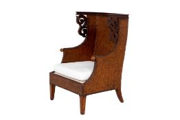 A RATTAN WOVEN WING ARMCHAIR