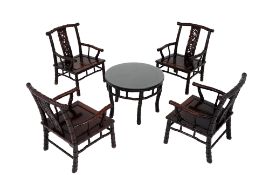 A SET OF FOUR ORIENTAL HARDWOOD ARMCHAIRS AND TABLE