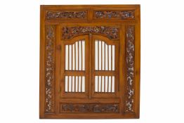 A CARVED WOOD DECORATIVE MIRROR