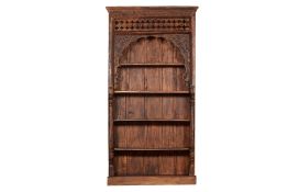 A TALL ANTIQUE DOORWAY ARCH CONVERTED INTO A BOOKCASE