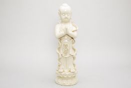 A LARGE CHINESE BLANC DE CHINE FIGURE OF A BOY