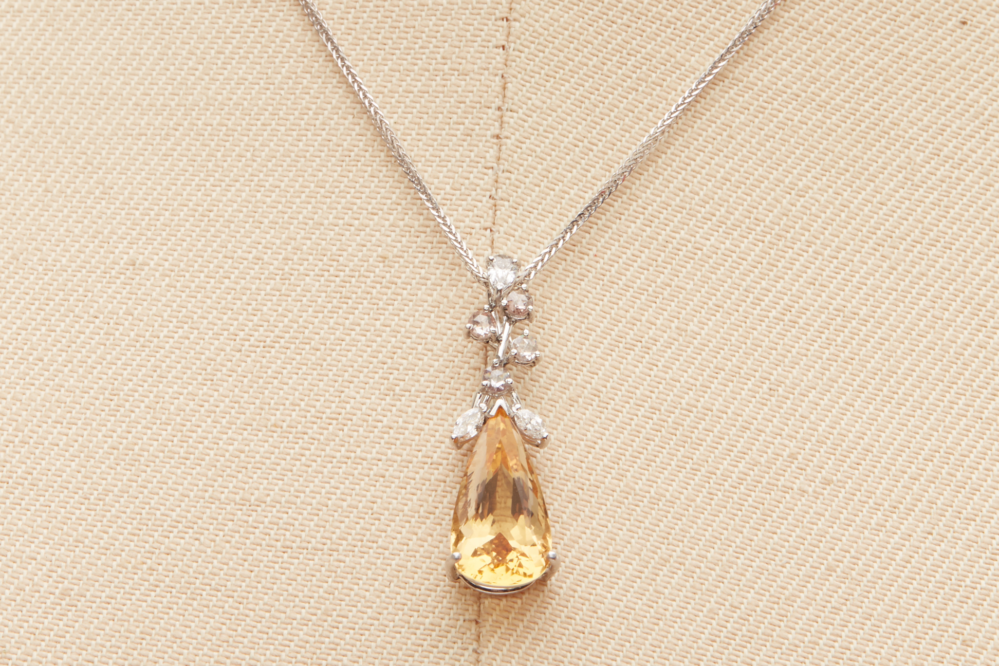 A CITRINE AND DIAMOND PENDANT ON CHAIN