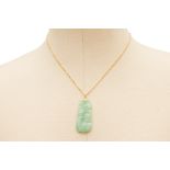 A CARVED JADE PENDANT ON CHAIN