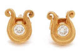 A PAIR OF HORSESHOE SHAPED DIAMOND STUD EARRINGS