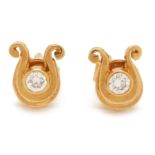 A PAIR OF HORSESHOE SHAPED DIAMOND STUD EARRINGS