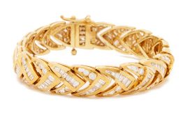 A LARGE YELLOW GOLD AND DIAMOND BRACELET
