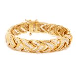 A LARGE YELLOW GOLD AND DIAMOND BRACELET