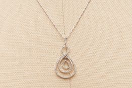 A DIAMOND FIGURE OF EIGHT LAYERED PENDANT ON CHAIN