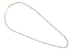 A GOLD AND EMERALD BEAD NECKLACE