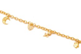 A GOLD AND DIAMOND CHARM BRACELET