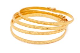 A SET OF FOUR HINGED YELLOW GOLD BANGLES