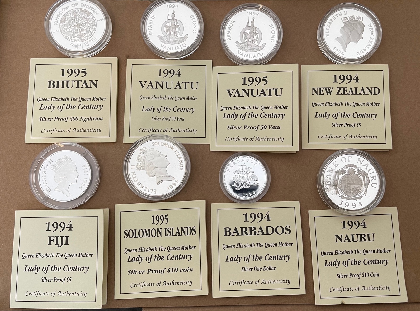 Lot of 8 Queen Mother Silver Proof Coins with certificates - each coin 31.47grams-apart from one 10g