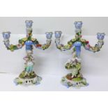 A pair of Meissen flower encrusted and figural candlesticks, height 28cm, a/f