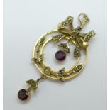 An Edwardian 9ct gold pendant set with seed pearls and garnets, lacking two seed pearls, 4.6g,