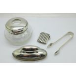 A silver topped hair tidy, a pair of silver sugar bows, a silver vesta case and a silver buffer