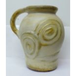 A large ceramic jug, height 30cm, handle a/f