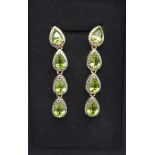 A pair of silver gilt and peridot earrings