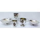 Three plated items with shipping line emblems and two similar dishes