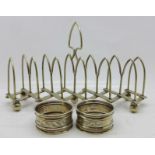 Two silver napkin rings, 18g, and a silver plated extending toast rack