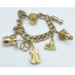 A 9ct gold charm bracelet with seven hallmarked 9ct gold charms including a guitar, total weight