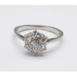 A white metal and diamond cluster ring, marked 18ct, 3g, N