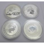 Four silver coins, each 1oz .999 fine silver; 2019 Britannia £2 coin, 2014 10 yuan Panda coin,