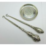 A small silver tray, marked '925 sterling', 71mm, and two silver handled button hooks