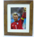 A framed signed photograph of David Beckham