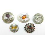 Two hallmarked Scottish silver brooches, lion and oval thistle, and three other Scottish brooches,