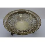 A pierced silver fruit bowl on three feet, retailed by Hancocks & Co., 152 New Bond Street,