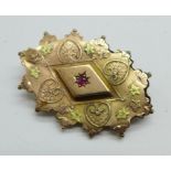 A c.1900 9ct gold brooch set with a ruby, 3.8g, 27mm x 39mm, (gold front lifting slightly, metal