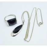 A silver ring and matching necklace, set with faceted black stones, ring size N