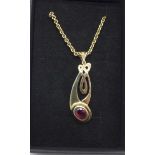 A 9ct gold chain with a yellow metal and red stone Celtic style pendant, chain 4.7g