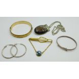 A rolled gold bangle, a child's silver bangle, a pair of silver earrings, a pendant and chain and