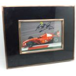 A signed picture of Michael Schumacher, framed