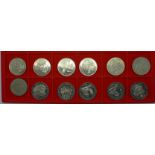 Twelve 1 crown coins; eight Sherlock Holmes and four Robert Burns collections