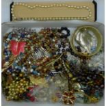 A collection of costume jewellery including bead necklaces, brooches, etc.