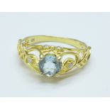 A silver gilt ring set with blue topaz and diamond simulants, S