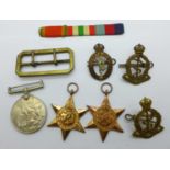 Three WWII medals marked to W164041 J.B.C. Lowe with badges, buckle and ribbon bar