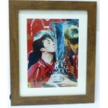 A framed signed photograph of Robbie Fowler with UEFA Cup