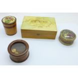 Three treen items including a dice shaker and a circular box depicting a religious scene in the