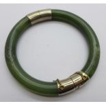 A white metal mounted jade bangle