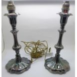 A pair of silver candlesticks, made into table lamps, 24cm, continental marks